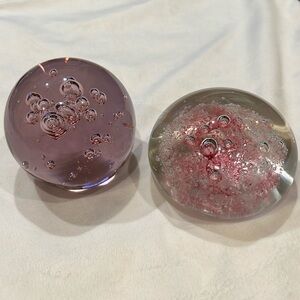 2 glass paperweights controlled bubbles 1. sphere pink  2. Dome clear/pink.